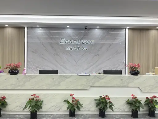 Eranntex reception desk with the Eranntex and 逸云天 name wall