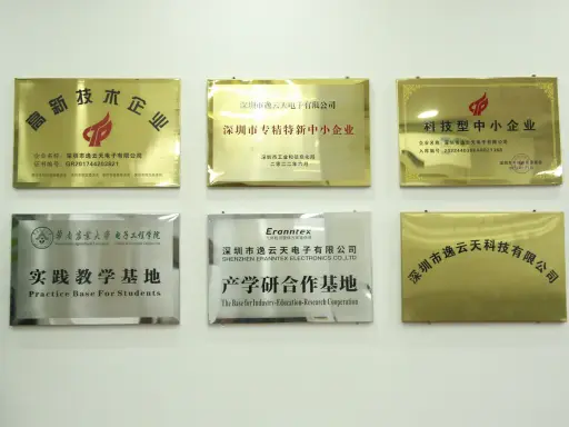 Six recognition plaques mounted on the showroom wall