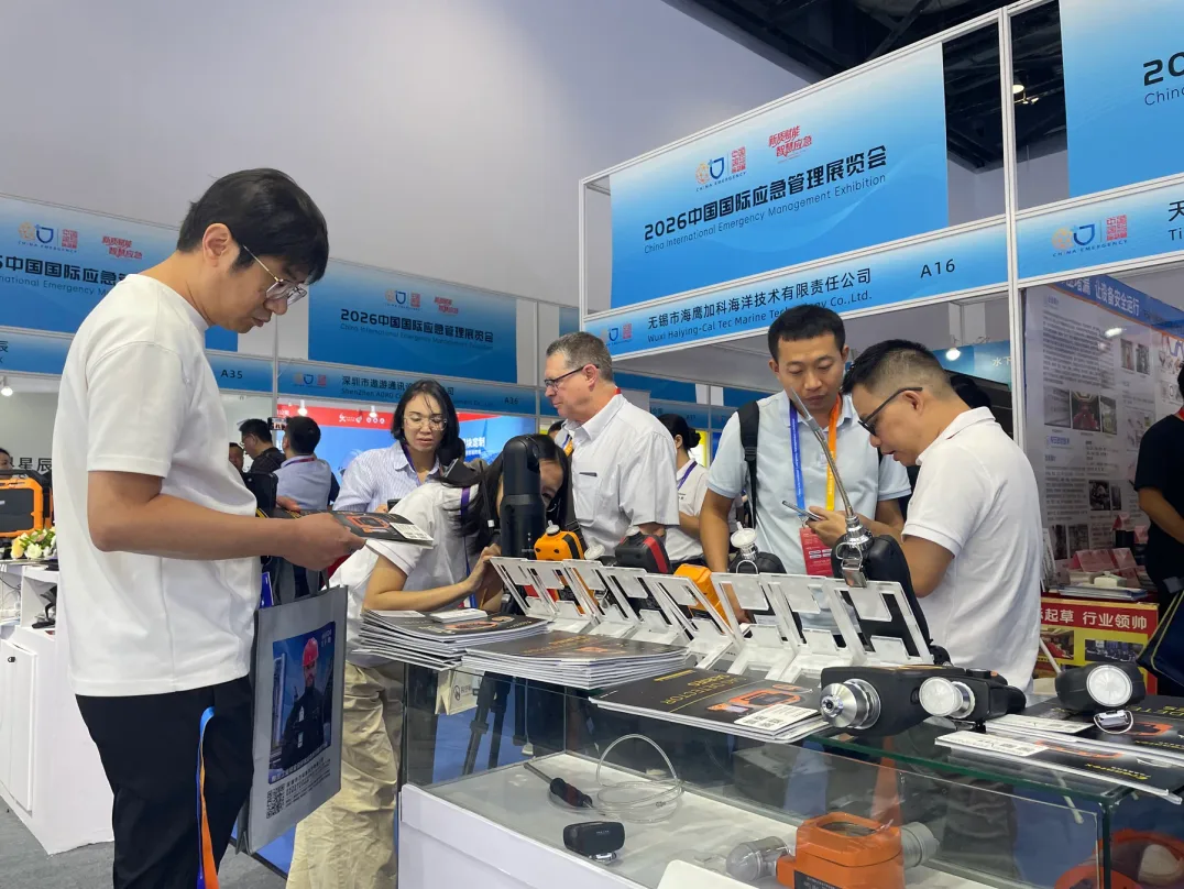 Visitors discussing instruments at the exhibition product counter