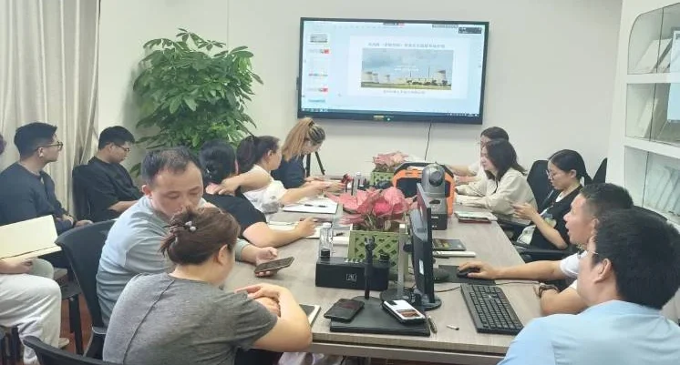 Team members reviewing an instrument during a project discussion